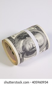 Bribery - The roll of dollar bills with plastic band over the eyes - Shutterstock ID 405960934