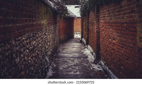 Brick Alleyway On A Snowy And Damp Day