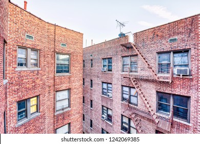 Brick Apartment Condo Building Roof Exterior Architecture In Fordham Heights Center, Bronx, NYC, Manhattan, New York City With Fire Escapes, Windows, Ac Units In Morning, Satellite Dish, Antenna, USA