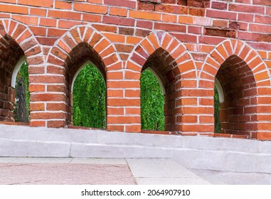 Brick arches of parapet of ancient stone bridge