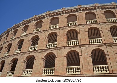 
brick arena with arches and decorative parapets