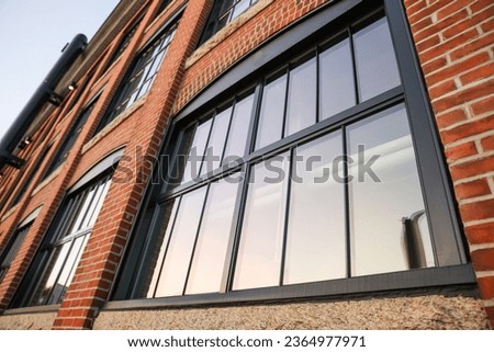 brick building facade, timeless urban charm, textured surface, architectural heritage, vintage atmosphere, cityscape, historic landmark, timeless appeal