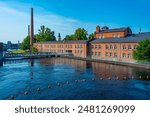 Brick buildings alongside Tammerkoski channel in Tampere, Finland.