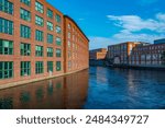 Brick buildings alongside Tammerkoski channel in Tampere, Finland.