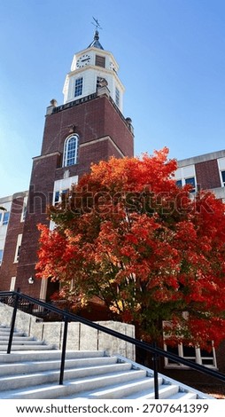 Brick campus Pulliam Hall building with clock tower and vibrant fall colors in Carbondale Illinois.