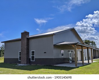 Brick Chimney Addition To Post Frame Construction Residential Home With Recreational Space Added Under One Metal Roof With Metal Siding