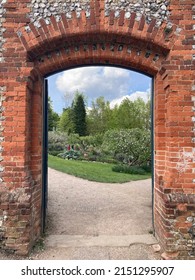 Brick gateway to a walled garden in England