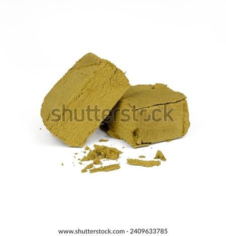 A brick of hashish, isolated on a white background, front and top view