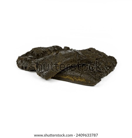 A brick of hashish, isolated on a white background, front and top view