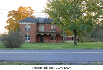 A Brick Historic Home In Missouri With Autumn Leaves