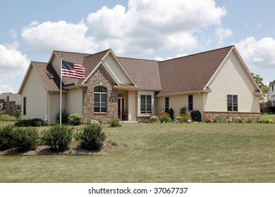 Brick Home In Suburbs With American Flag