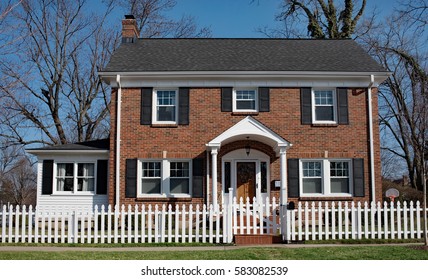 Brick House with White Picket Fence