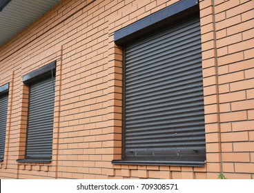 Brick House Windows With Rolling Shutter For House Protection.