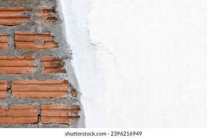 brick layer structure and concrete wall painted white under construction, close-up with copy space for advertising messages