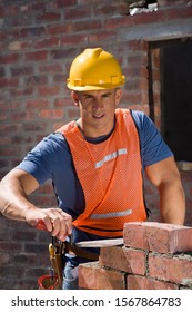 Brick Layer Working At Construction Site