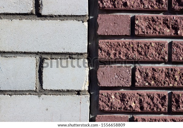 Brick laying on new technologies made up of red\
and white bricks.