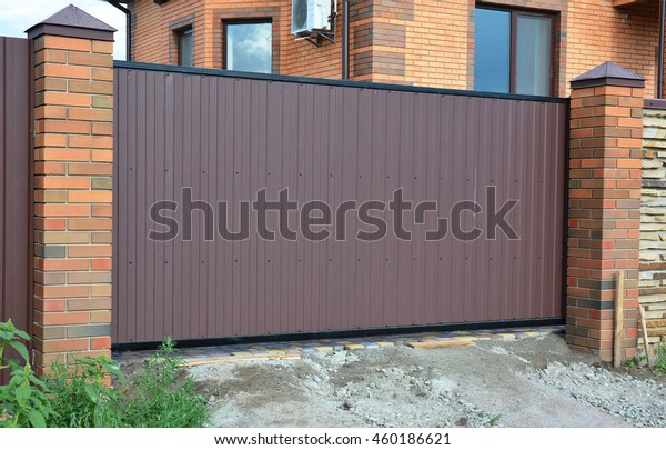 Brick and Metal Fence with Metal Gate of Modern\
Style Design Decorative Cracked Brick Wall Surface Exterior. Steel \
Fence Gate House Design\
Ideas.