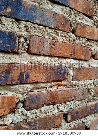 Brick is one of the materials used as a wall material. Bricks are made of clay that are burned until they are reddish in color