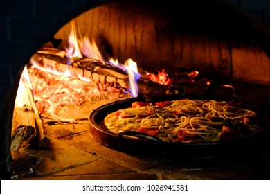 Brick Oven With Hot Pizza Cooking Inside