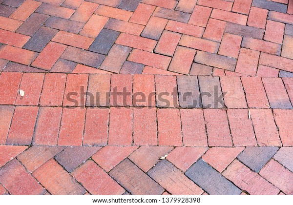 Brick pavers, shown here in a\
herringbone pattern divided by a double band of soldier course is a\
popular landscaping material choice in the southern United\
States.
