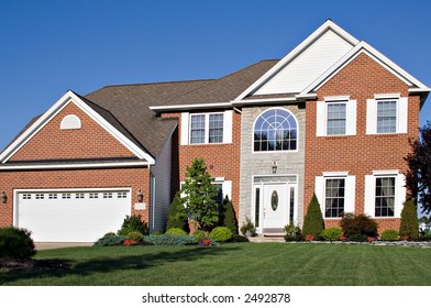 Brick And Stone Colonial Home In The Suburbs.