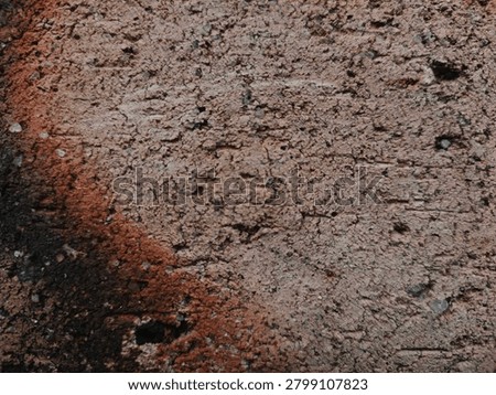A brick texture has a rough and gritty surface with visible pores and small indentations.