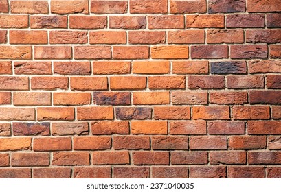 Brick tile wall abstract background. Exterior view of a house made of blocks lined with cement. Exterior wall made of decorative brickwork.