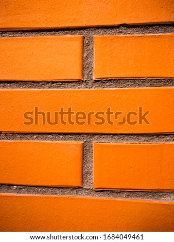 Brick tile wall as orange summer bright texture background backdrop vertical orientation