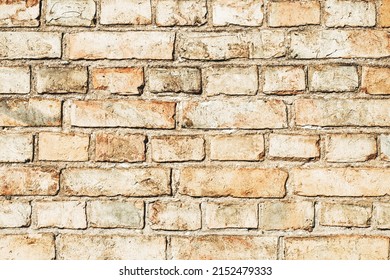 Brick wall background. Urban rustic texture. Antique house exterior wall. Vintage abandoned building architecture. Red brick construction. Uneven blocks pattern.