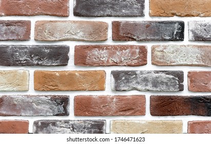 Brick wall of beige and brown bricks. Background and texture of brickwork.