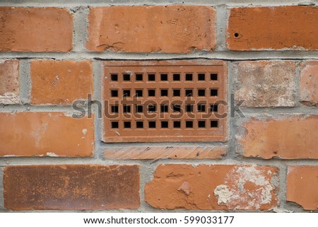 brick wall with a close up showing a ventilation brick
