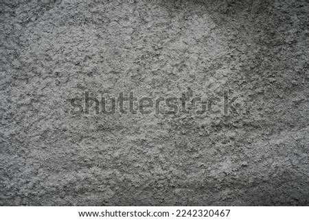 brick wall covered with rough cement mortar