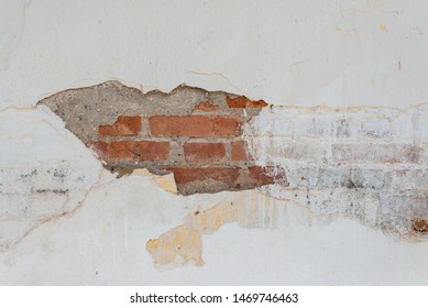 Brick wall with damaged stucco surface. Construction background with cement wall background. 