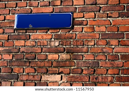 brick wall with an empty streetsign