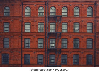 Brick Wall Factory Wall With Rounded Window And Ladder. 