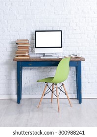 brick wall interior work desk and green chair 