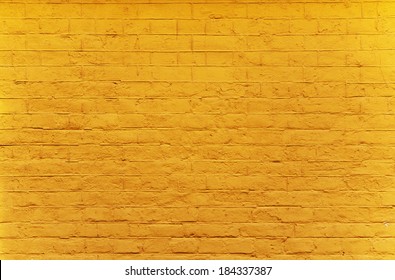 brick wall painted in bright yellow