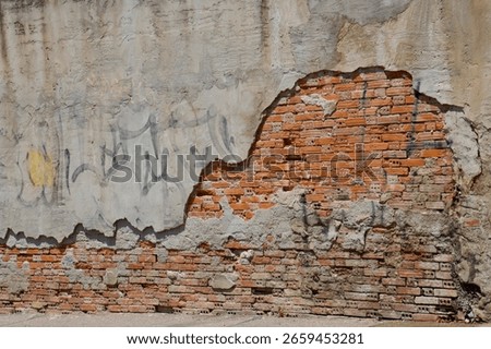brick wall with plaster and graffiti