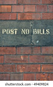 Brick Wall With Post No Bills Sign