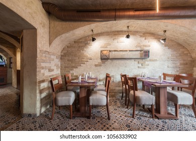 Brick Wall And Rustic Tiled Floor In Restaurant Interior