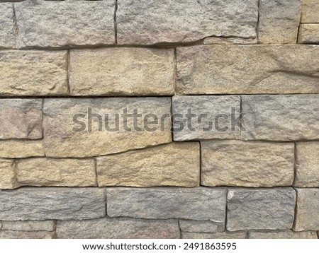 Brick wall texture, closeup of an old exterior surface as a background. Building face wall, convex joint line between dissimilar faded bricks brings character and dimensionality to vintage masonry.