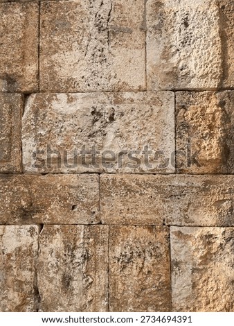 Brick wall texture, closeup of an old exterior surface as a background. Building face wall, convex joint line between dissimilar faded bricks brings character and dimensionality to vintage masonry.
