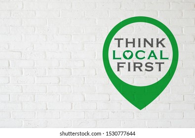 Brick wall with THINK LOCAL FIRST - Shutterstock ID 1530777644