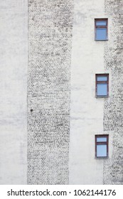Brick wall with three windows