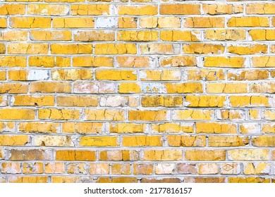 Brick wall with unusual yellow bricks made of whole yellow bricks and broken yellow bricks for an abstract yellow background - Shutterstock ID 2177816157