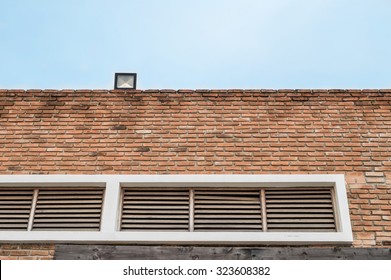 Brick wall with window at the building background