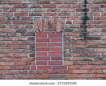 bricked-up window in a brick wall