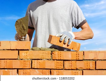 Bricklayer Laying Bricks To Make A Wall