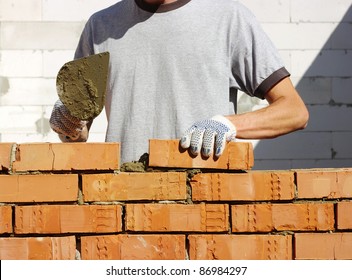 Bricklayer Laying Bricks To Make A Wall