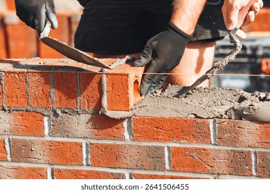Bricklayer laying bricks on building site